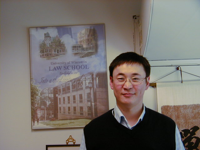 Professor Amarsanaa, pictured with the Law School poster behind him.