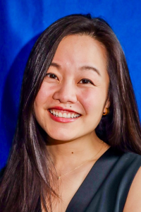 A headshot photo of Jilene Chua with long brown hair and smiling