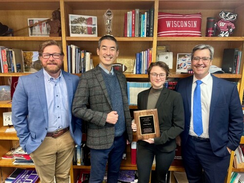 Winner stands together with their professors and the dean.