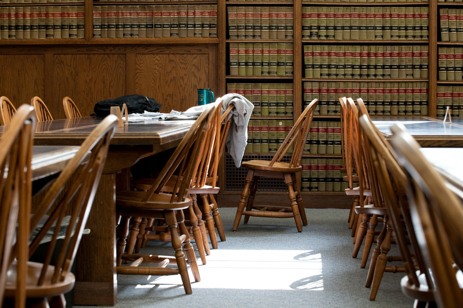 UW Law Library with sweatshirt over chair and coffee mug on table